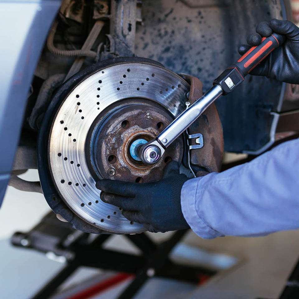 Man fixing brake disk. Selective focus.