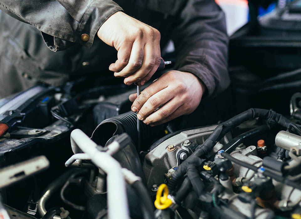 Auto mechanic repairing car. Selective focus.