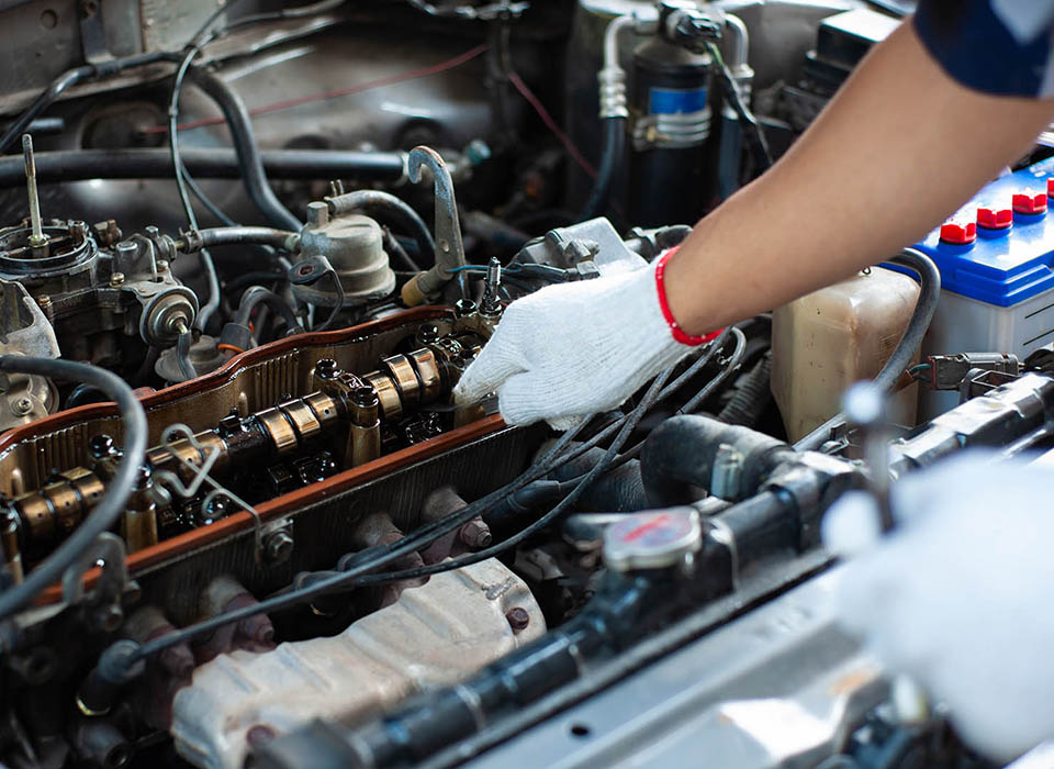 The mechanic is tuning the car's engine.